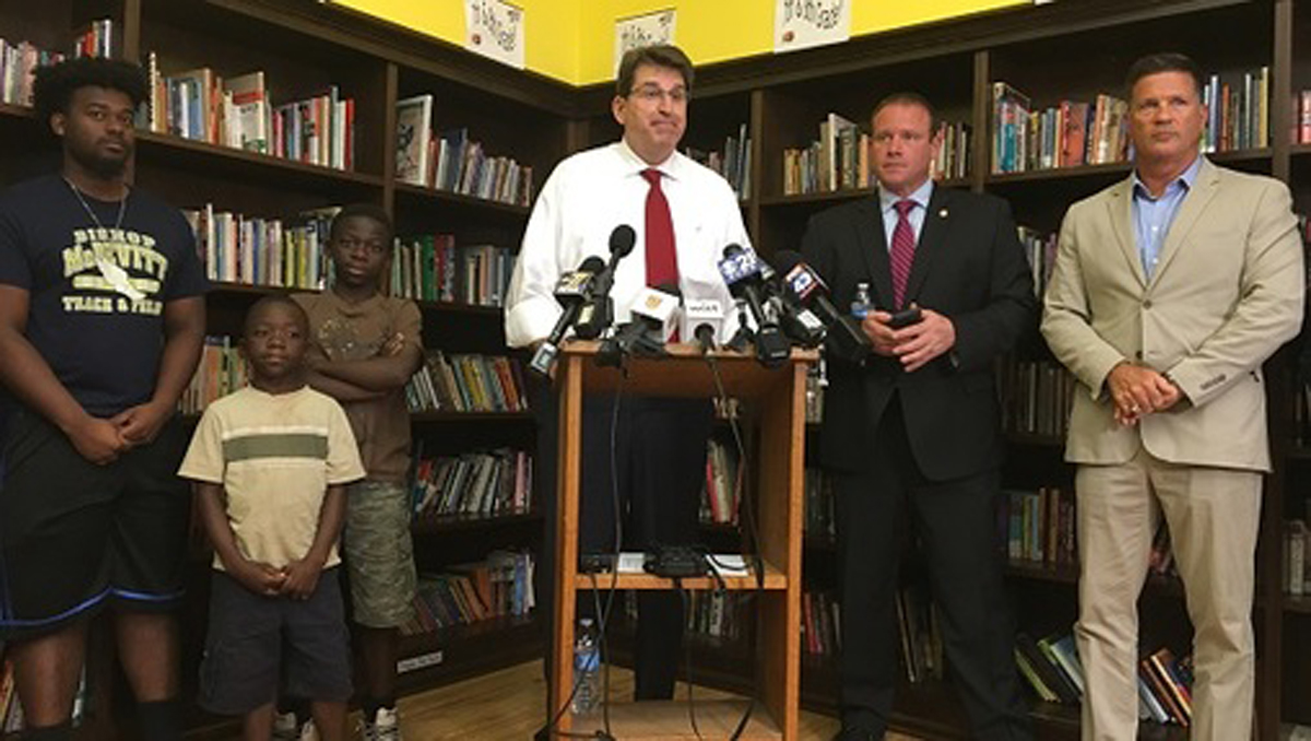  DiSanto and other lawmakers stand with students to announce the bill inside Harrisburg's Joshua Learning Center. (Katie Meyer/WITF) 