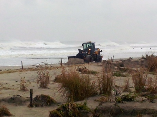 <p><p>Crews in Ocean City are rushing to build up the dunes before high tide. (Tom Mac Donald/WHYY)</p></p>

