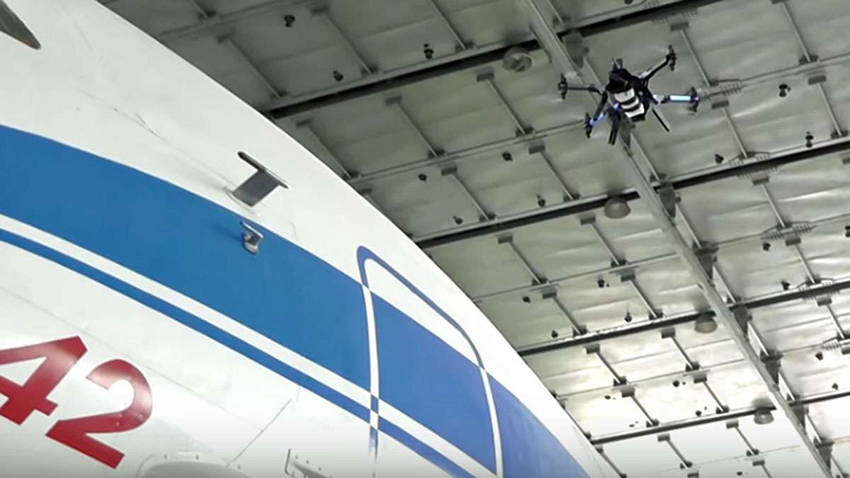 A Luftronix drone is shown inspecting the exterior of a plane.