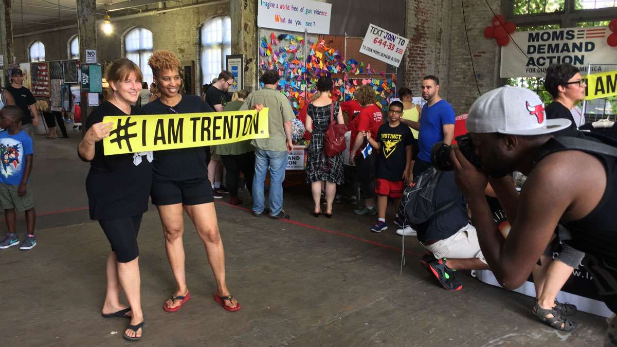 People express their pride by holding banners at Art All Night in Trenton. (Alan Tu/WHYY)