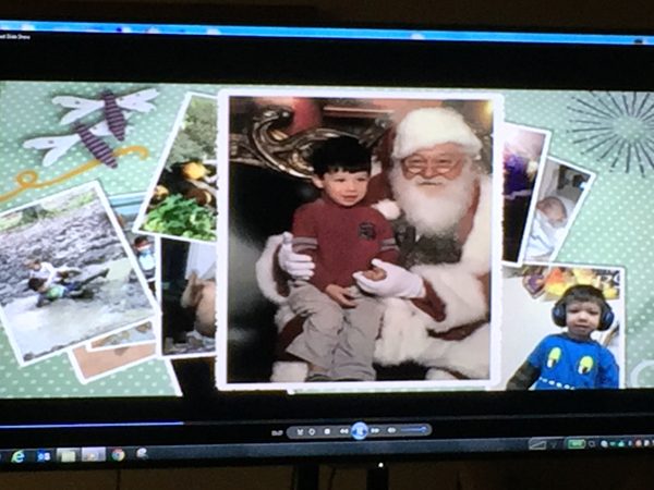 Photos on a computer screen of slain Brendan Creato, sitting on Santa's lap, etc.
