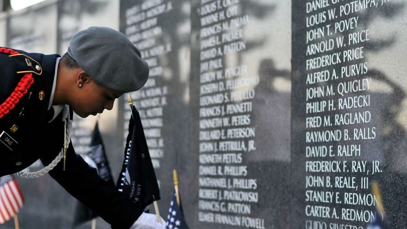 POW/MIA flags are placed near the names of ten soldiers missing in action during a ceremony at the Vietnam Veterans Memorial in Philadelphia.