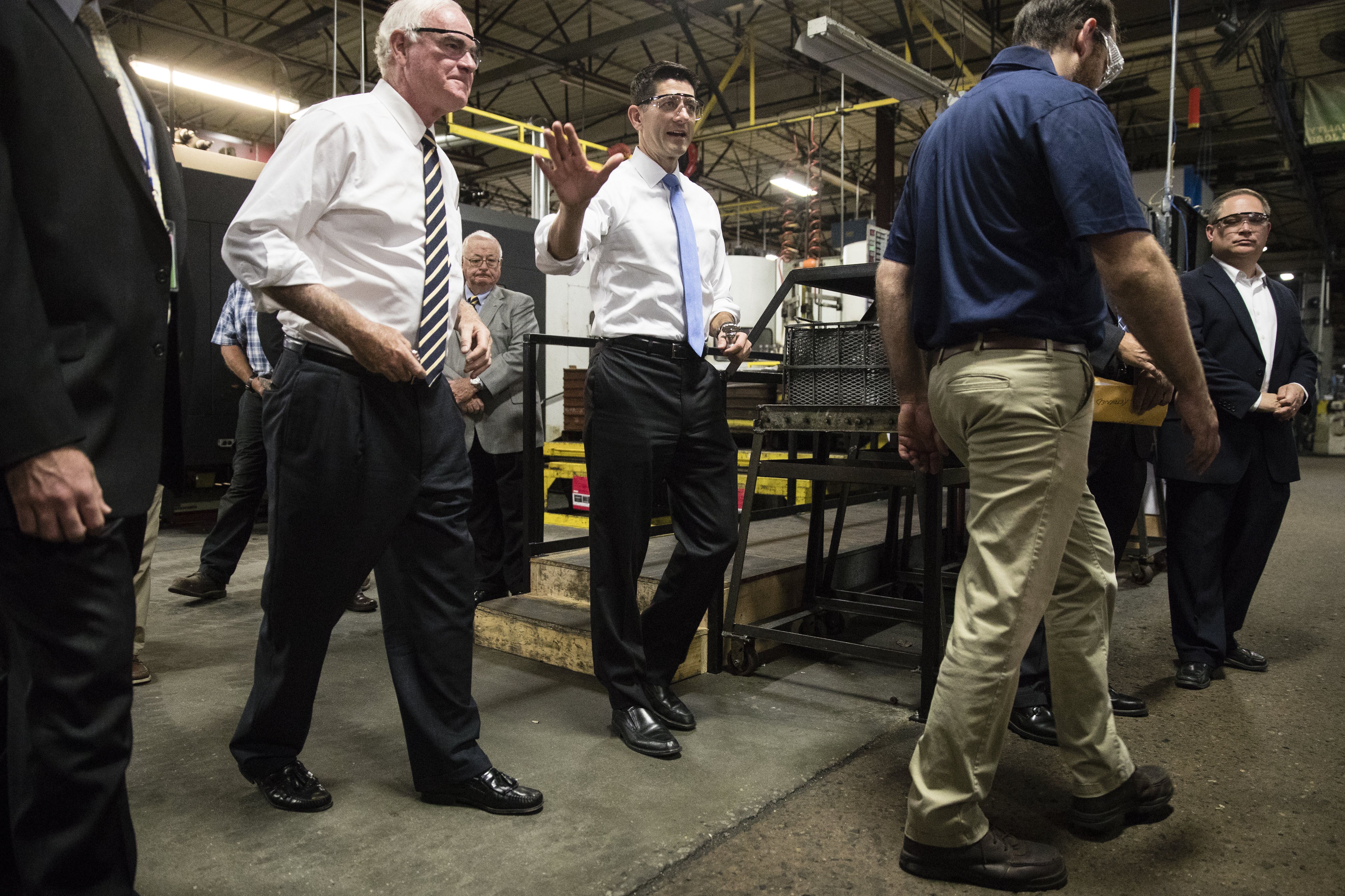 Speaker of the House Paul Ryan and Rep. Pat Meehan, in protective eyewear with their shirt sleeves rolled up, visit a factory