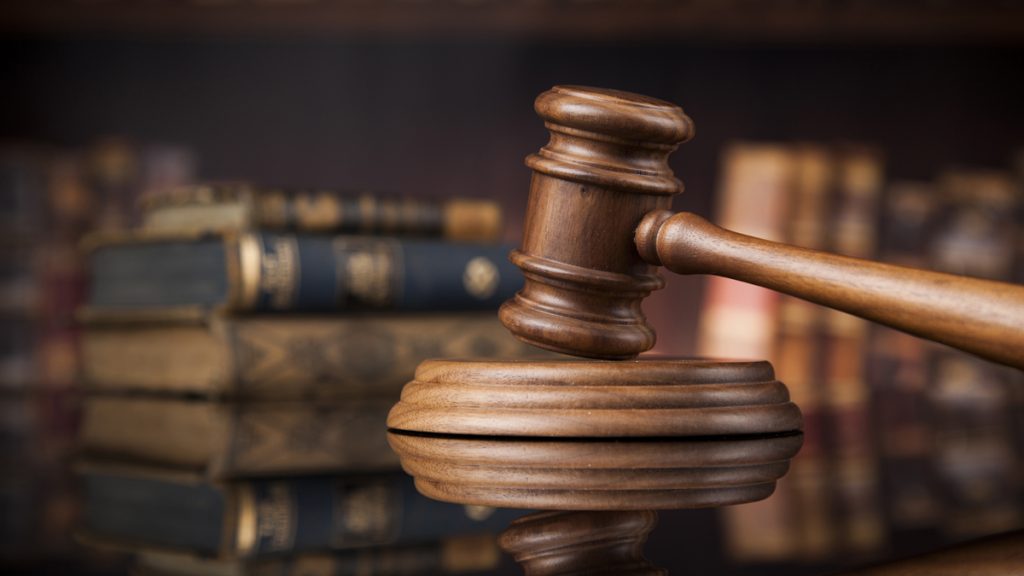 Court gavel,Law theme, mallet of justice Court gavel, brown wood against a dark background