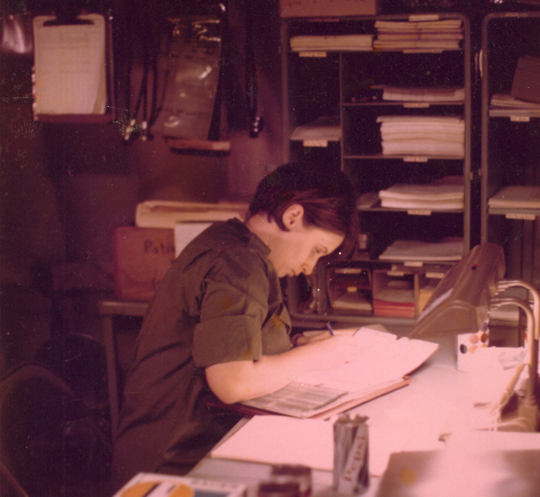 Marsha Four works at her desk at the 18th Surgical Hospital in Vietnam.