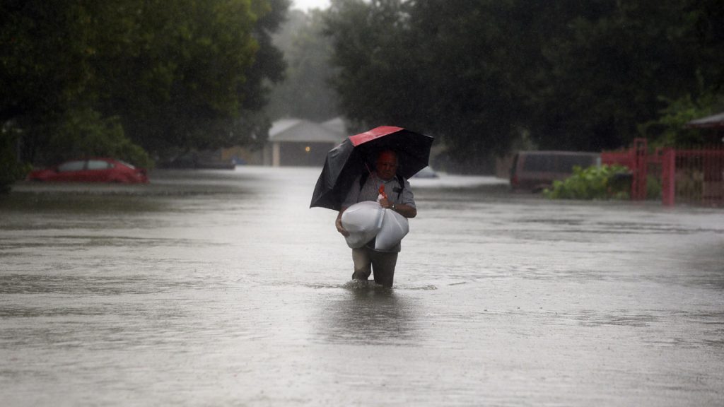 ap_17240703910233 Eldemiro Chavaria walks in floodwaters from Tropical Storm Harvey as he leaves his neighborhood in Houston, Texas, Monday. Forecasters are evaluating whether New Jersey will be n the path of a hurricane this season.(AP Photo/LM Otero)