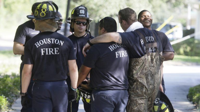 Firefighters gather during a door-to-door survey of a neighborhood that was hit by floodwaters from Tropical Storm Harvey in Houston, Thursday, Aug. 31, 2017. The first responders are checking homes for any emergency needs of residents as the cleanup commences after the historic storm. (LM Otero/AP Photo) 