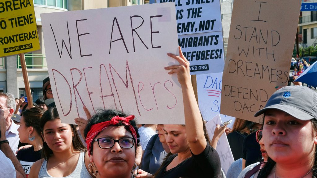 daca16x9 Supporters of the Deferred Action for Childhood Arrivals, or DACA chant slogans and hold signs while joining a Labor Day rally in downtown Los Angeles on Monday, Sept. 4, 2017.