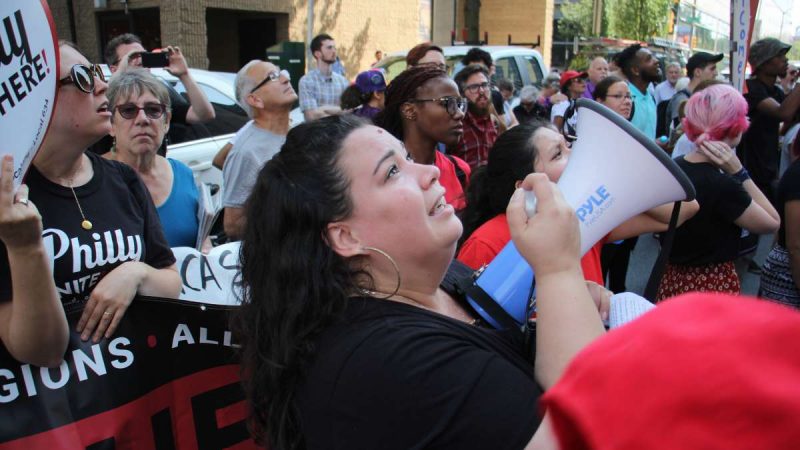 Erika Almiron, of the Latino immigrant rights organization Juntos, pleads for the continuation of DACA with protesters who gathered on Arch Street outside the Federal Prison.