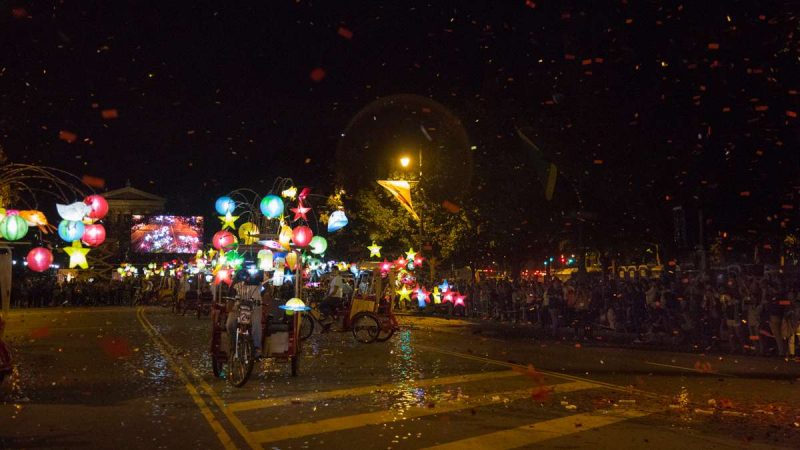 Pedicabs adorned with colorful lanterns perform a dance on the Ben Franklin Parkway to kick off the 100th anniversary of the Parkway. (Emily Cohen for NewsWorks)