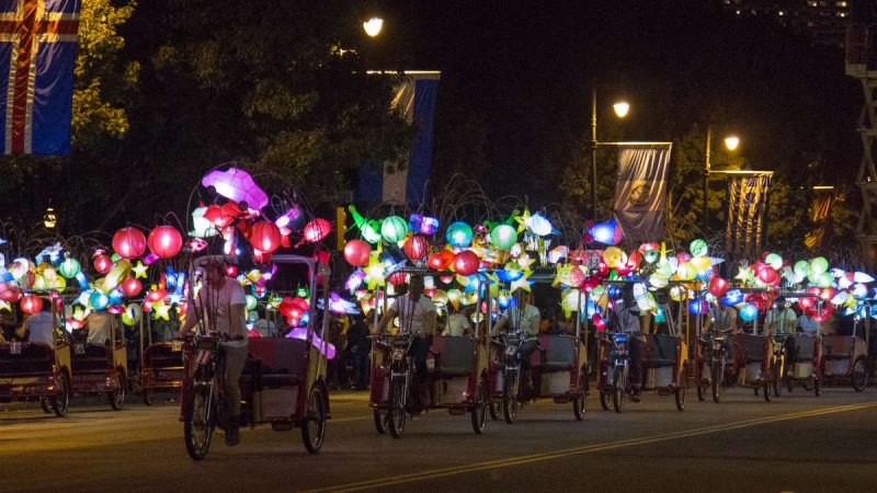 Pedicabs adorned with colorful lanterns perform a dance on the Ben Franklin Parkway to kick off the 100th anniversary of the Parkway. (Emily Cohen for NewsWorks)