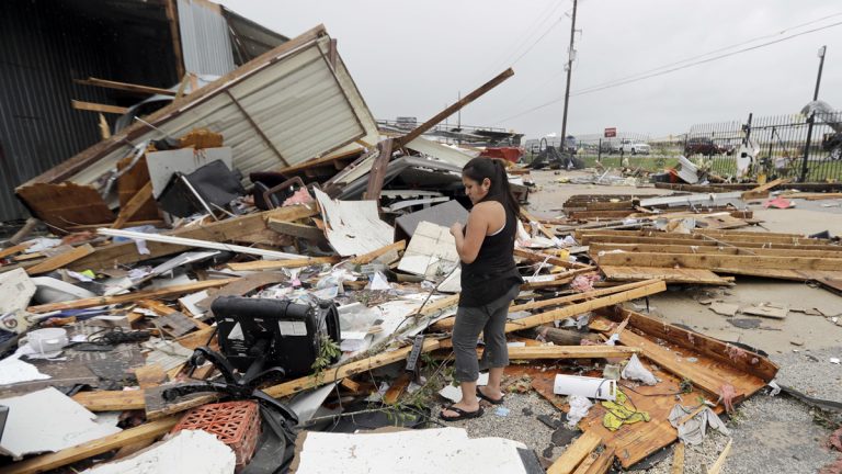  Jennifer Bryant looks over the debris from her family business destroyed by Hurricane Harvey Saturday, Aug. 26, 2017, in Katy, Texas. Harvey rolled over the Texas Gulf Coast on Saturday, smashing homes and businesses and lashing the shore with wind and rain so intense that drivers were forced off the road because they could not see in front of them. (AP Photo/David J. Phillip) 