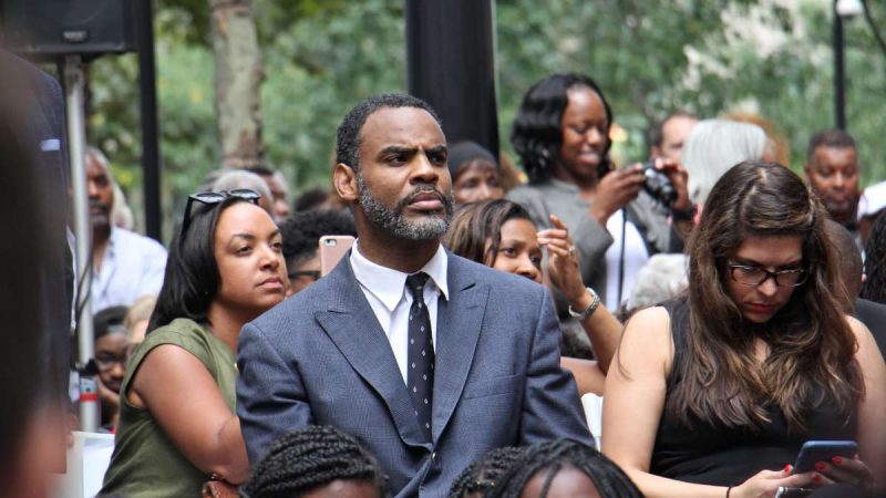 Jon Smith, the great-great-great-nephew of Octavius Catto, seated, blue suit