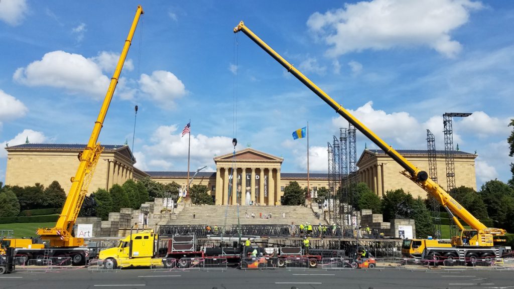 made-in-america-1 Workers set up the stage for the Made in America concert on the Ben Franklin Parkway. (Peter Crimmins/WHYY)