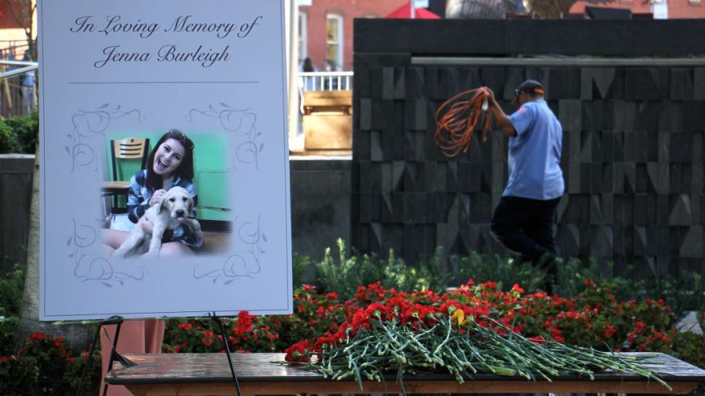 memorial_20170907_1125391883 Carnations are piled beside a portrait of murder victim Jenna Burleigh after a memorial service at Temple University's Founder's Garden