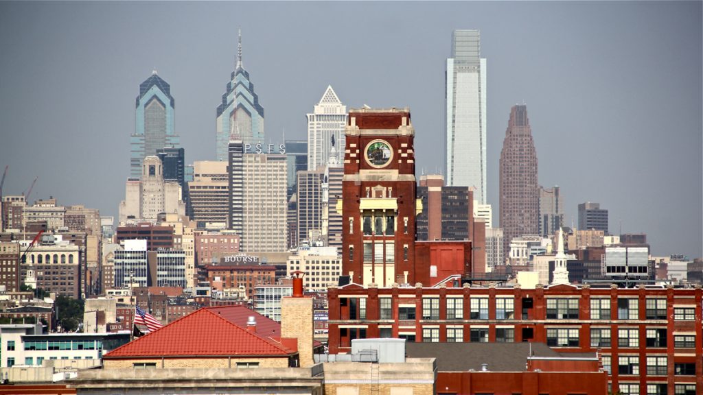 philly-skyline-from-camden Census data show that poverty in Camden (foreground)is ebbing, while across the river in Philadelphia, the poverty rate remains flat. (Emma Lee/WHYY, file)