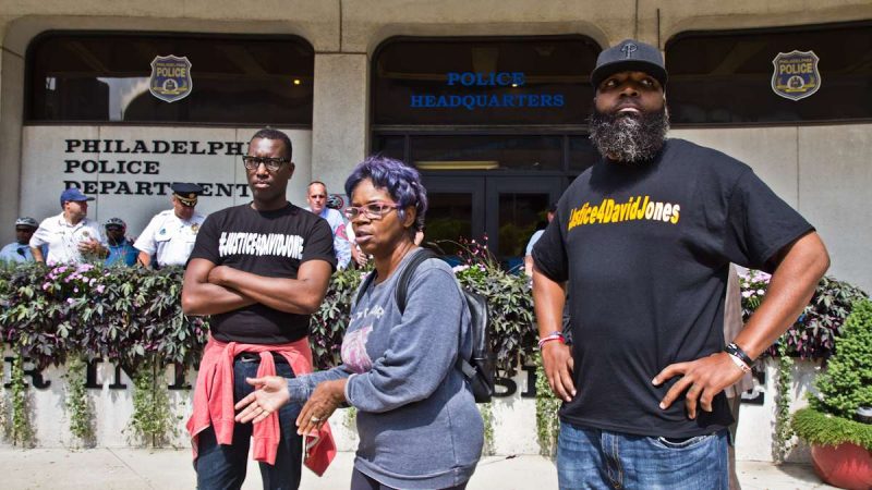 Asa Khalif, organizer of Black Lives Matter's Philadelphia chapter, Rowena Faulk, and Isaac Gardner, protested outside police headquarters Thursday to demand murder charges be brought against officer Pownall.