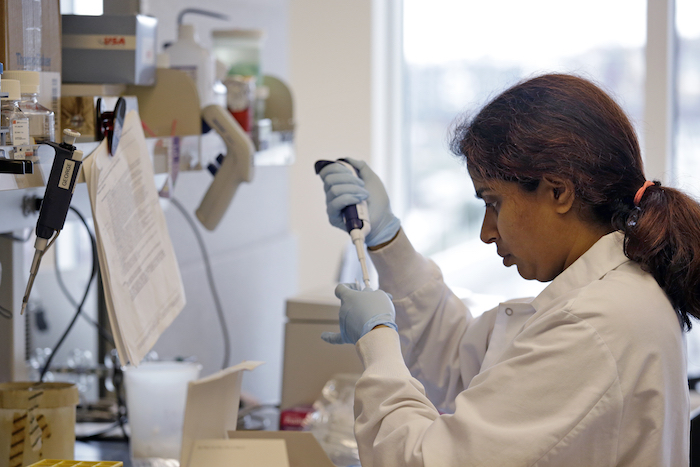 In this photo taken March 28, 2017, research technician Ashwini Balakrishnan works in the immunotherapy research lab of Dr. Stanley Riddell at the Fred Hutchinson Cancer Research Center in Seattle. (AP Photo/Elaine Thompson)