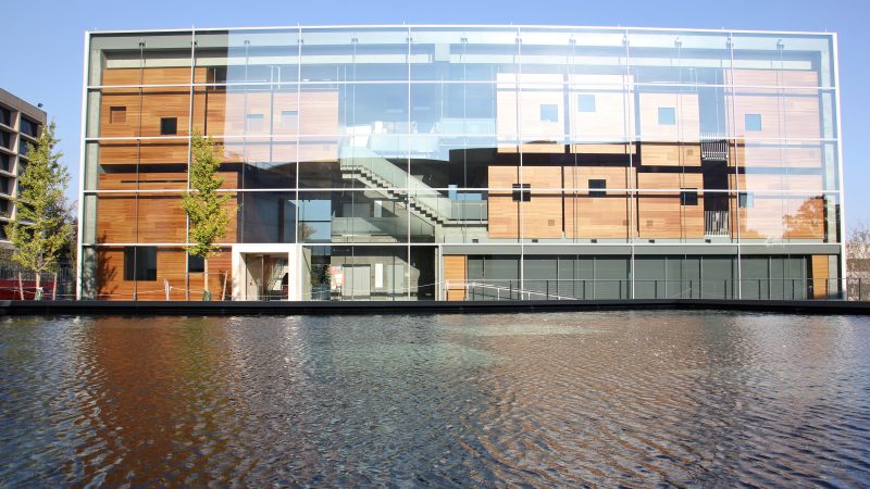 The practice rooms of the New Music Building loom above a reflecting pool. (Emma Lee/WHYY)