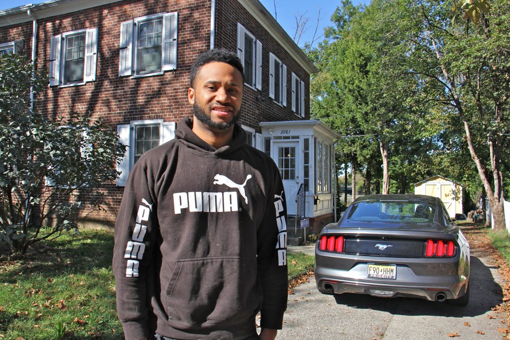 2017 10 18-e lee-kenneth hammond-camden-poverty rate Kenneth Hammon stands in front of his brick town house in Camden. There is a Mustang car in the driveway