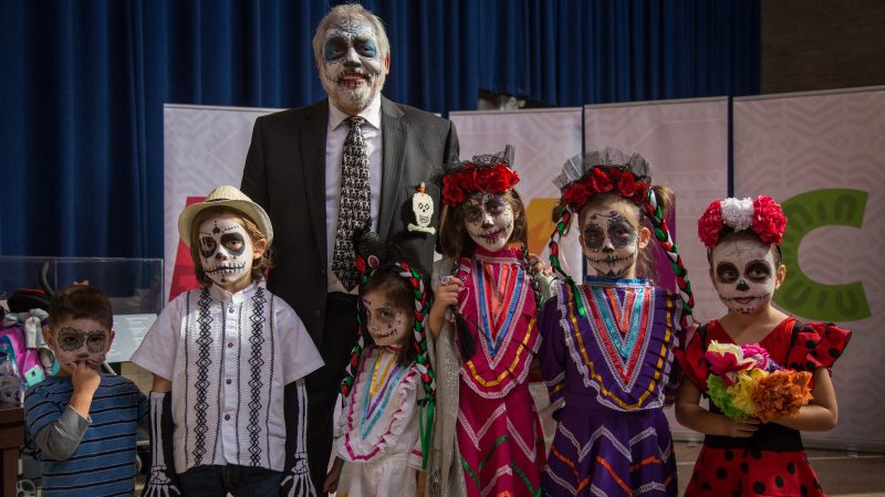 A. Peter Ojeda stands with his grandchildren all in traditional sugar skull face paint in celebration of Dia de los Muertos at Penn Museum's annual Day of the Dead