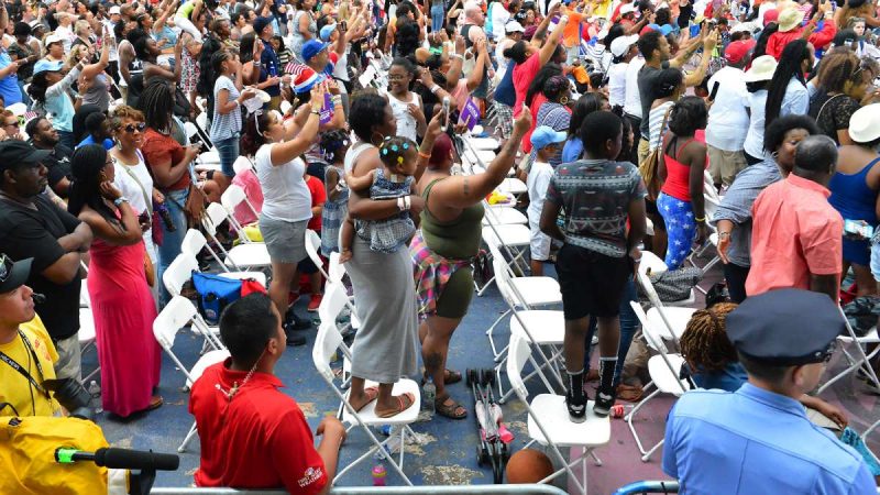 Members of the audience in the seated section enjoy the music during the Fourth of July concert on the Parkway.