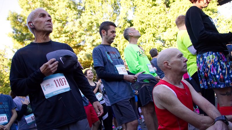 Kevin Peter, of West Mt. Airy, takes a knee in protest during the National Anthem at the start of the WXPN 5K, on Sunday. (Bastiaan Slabbers for WHYY)