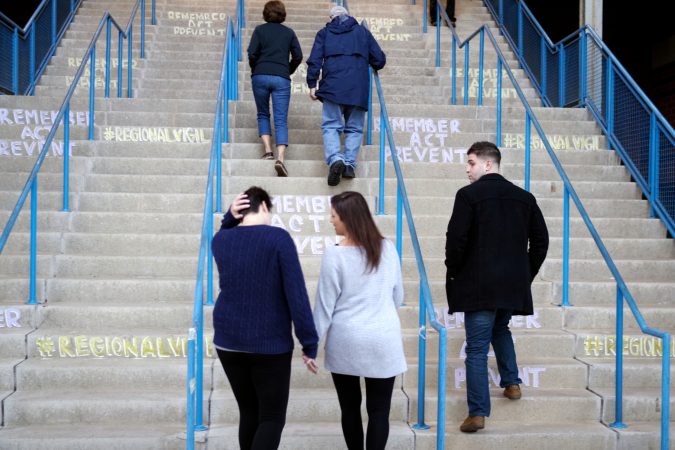 Attendees climb the stairs at Camden Waterfront Stadium for a the Regional Candlelight Vigil for the victims of drug addiction. (Bastiaan Slabbers for WHYY)