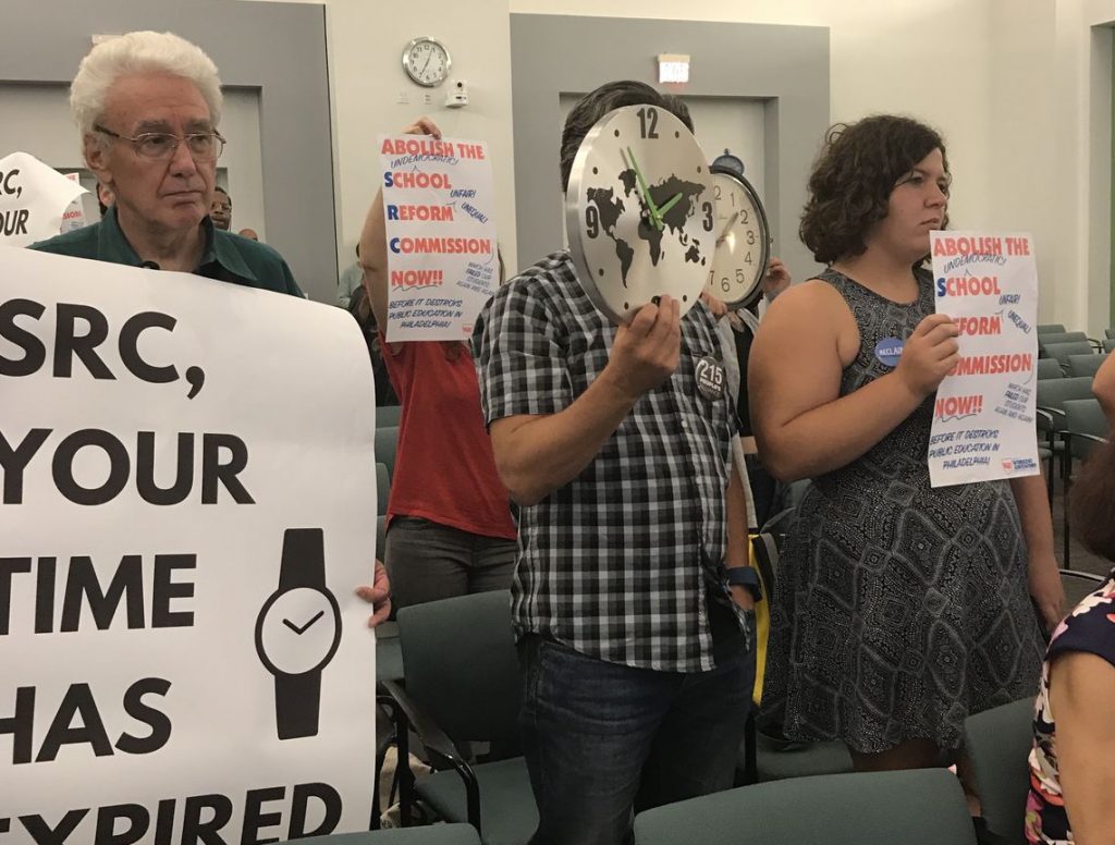 6897053985558964-fullsizerender.full Protesters including retired teacher Ron Whitehorne (left) at a recent School Reform Commission meeting demanded that the body vote to dissolve itself and return the Philadelphia School District to local control.