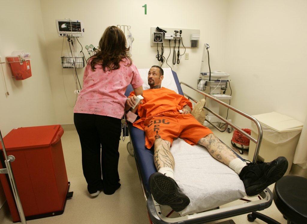 Jay Allen Herman, Dulcelena Solorio A registered nurse treats an inmate at San Quentin State Prison