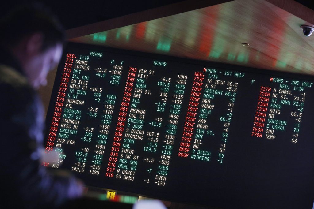 Sports Betting In this Jan. 14, 2015, file photo, odds are displayed on a screen at a sports book owned and operated by CG Technology in Las Vegas. (John Locher/AP Photo, File)