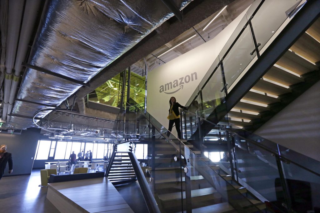 An Amazon worker walks down steps in a company office before an event announcing several new Amazon products by the company, Wednesday, Sept. 27, 2017, in Seattle. (Elaine Thompson/AP Photo)