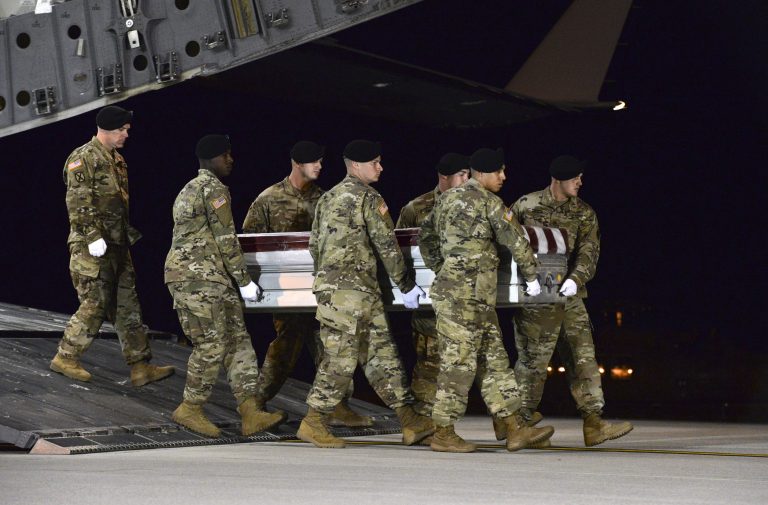 In this image provided by the U.S. Air Force, a U.S. Army carry team transfers the remains of Army Staff Sgt. Dustin Wright of Lyons, Ga., late Thursday, Oct. 5, 2017, upon arrival at Dover Air Force Base, Del. Wright, 29, of Lyons, Ga., was one of four U.S. troops and four Niger forces killed in an ambush by dozens of Islamic extremists on a joint patrol of American and Niger Force.