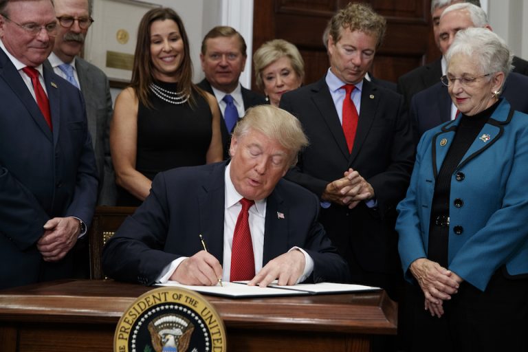 President Donald Trump signs an executive order on health care in the Roosevelt Room of the White House, Thursday, Oct. 12, 2017, in Washington. (AP Photo/Evan Vucci)