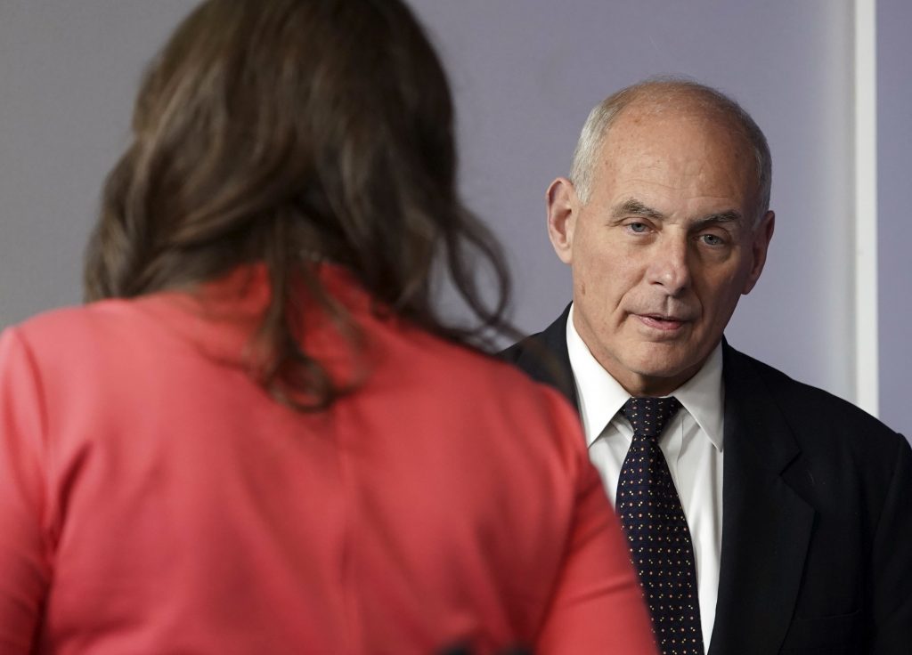 John F. Kelly, Sarah Huckabee Sanders White House Chief of Staff John Kelly walks past White House press secretary Sarah Huckabee Sanders to begin speaking to the media during the daily briefing in the Brady Press Briefing Room of the White House, Thursday, Oct. 19, 2017.