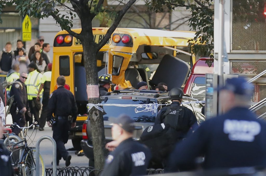 Manhattan Shooting Authorities respond near a damaged school bus Tuesday, Oct. 31, 2017, in New York. A motorist drove onto a busy bicycle path near the World Trade Center memorial and struck several people on Tuesday police and witnesses said.