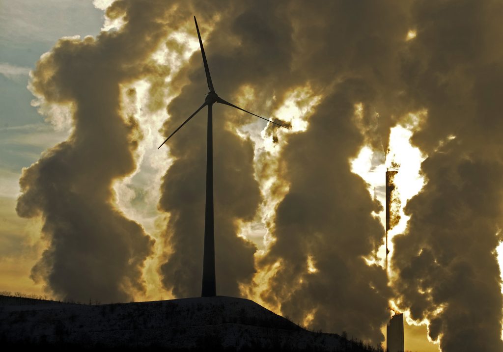 EU UN Climate Panel In 2010 file photo, a wind turbine is pictured in the in front of a steaming coal power plant in Gelsenkirchen, Germany.