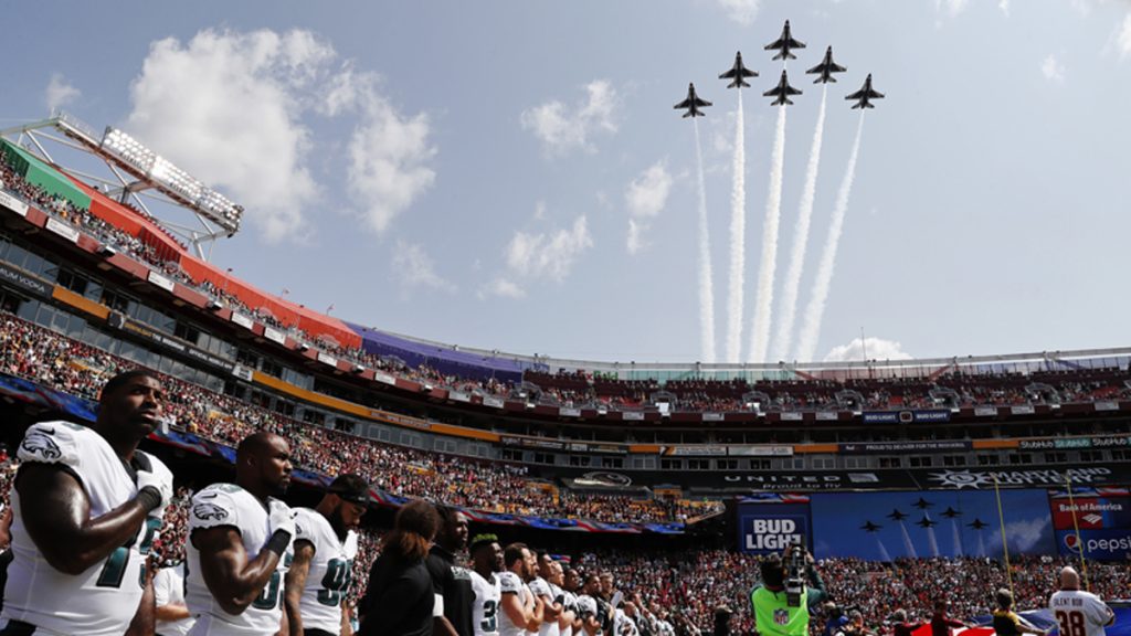Eagles Redskins Football In formation and against a blue sky, members of the U.S. Air Force Thunderbirds fly overhead while Eagles players look on, hands on their hearts, during the national anthem
