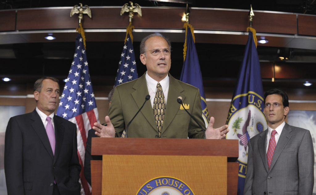John Boehner, Eric Cantor, Thomas Marino Man in an olive suit at podium