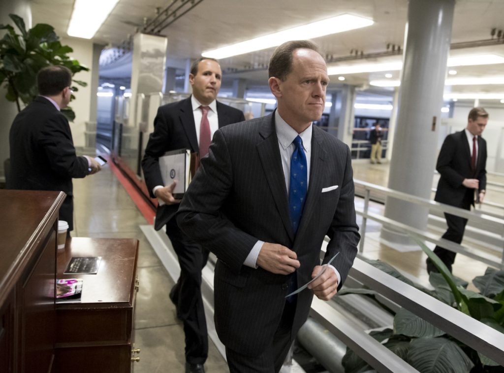 Pat Toomey Toomey walks through a hallway in the Capitol