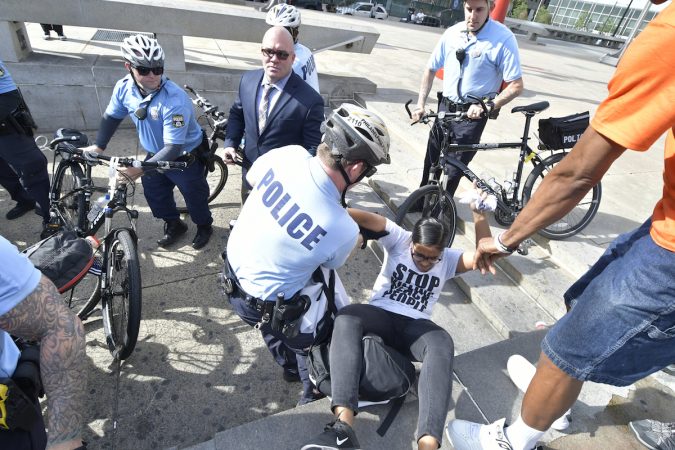 A scuffle between an officer and a woman