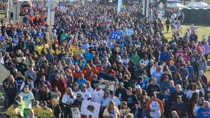 Different groups in matching colored tshirts walk in a group