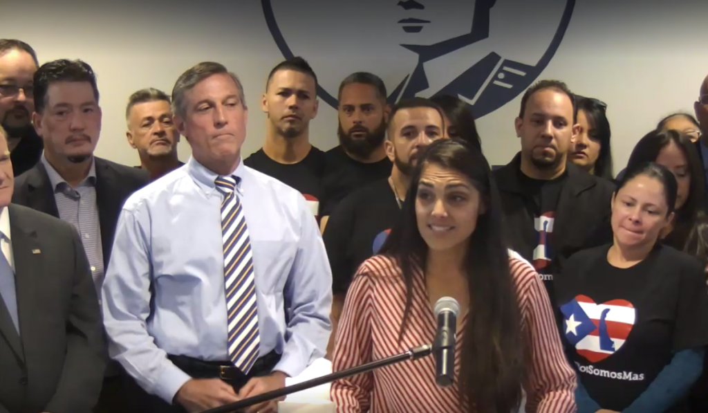 Delaware relief effort Delaware Hispanic liaison India Colon stands in front of Gov. John Carney as she talks about the devastation she saw in Puerto Rico after Hurricane Maria. (screenshot via Delaware.gov/Livestream)