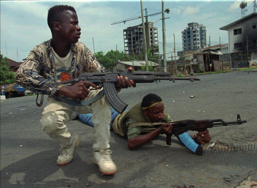 LIBERIA Fighters from the United Liberation Movement of Liberia (ULIMO) shoot their way through downtown Monrovia, LIberia Tuesday, April 16, 1996.