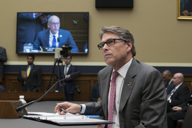 Rick-Perry Perry at a table with a mic