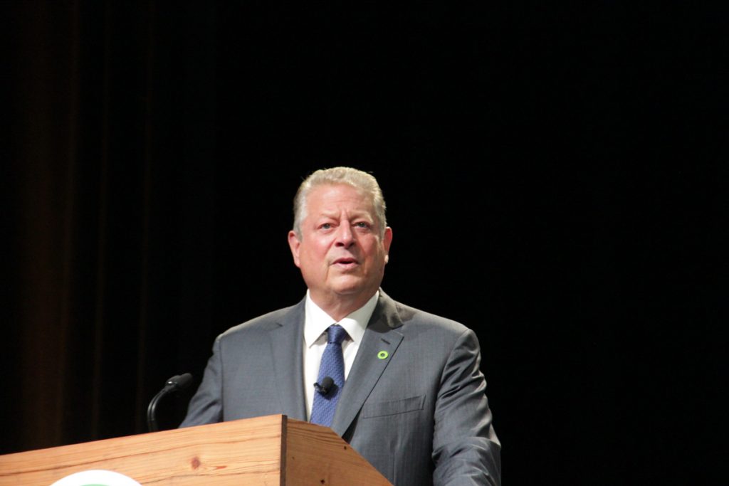 SIPARFgorex1200 Al Gore, grey suit, at a podium, black background