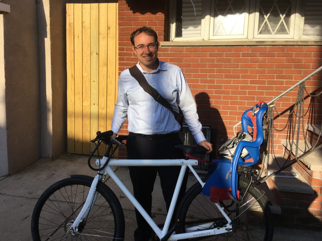 Andrew Stober stands with his VanMoof bike in front of his South Philly rowhome