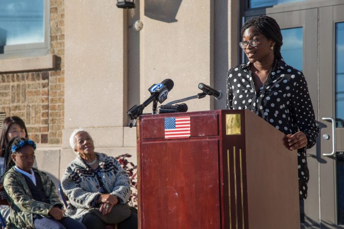 A girl speaks at a podium