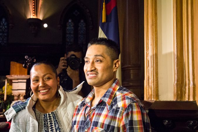 Javier Garcia Flores and his wife, Alma, wait inside the sanctuary of the First United Methodist Church on Arch Street in Philadelphia, before Flores will take his first steps outside the church since November of 2016. (Kimberly Paynter/WHYY)