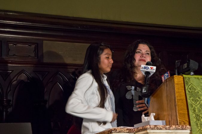 Adamaris Flores, Javier’s daughter, and Erika Almiron, Executive Director of Juntos, address the press inside the First United Methodist Church on Arch Street in Philadelphia. (Kimberly Paynter/WHYY)